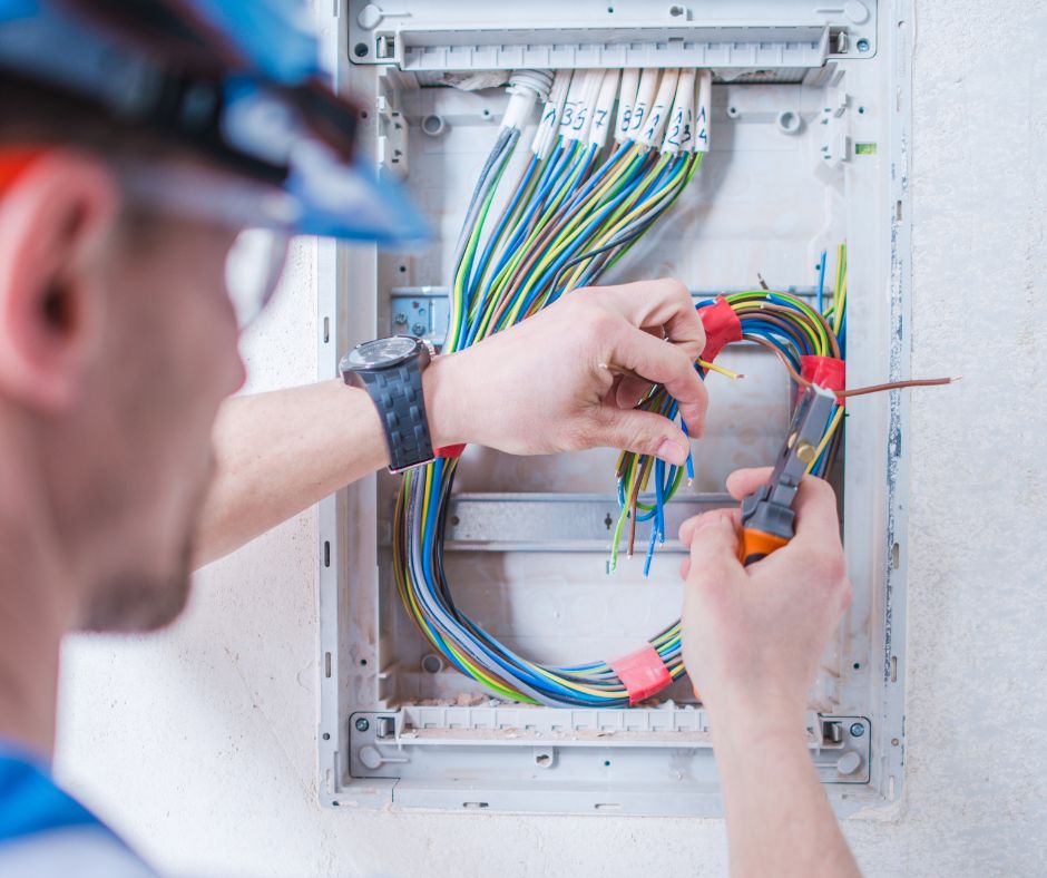 An electrician looking at wires