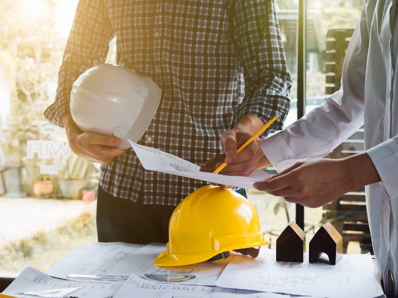 Construction workers writing on forms